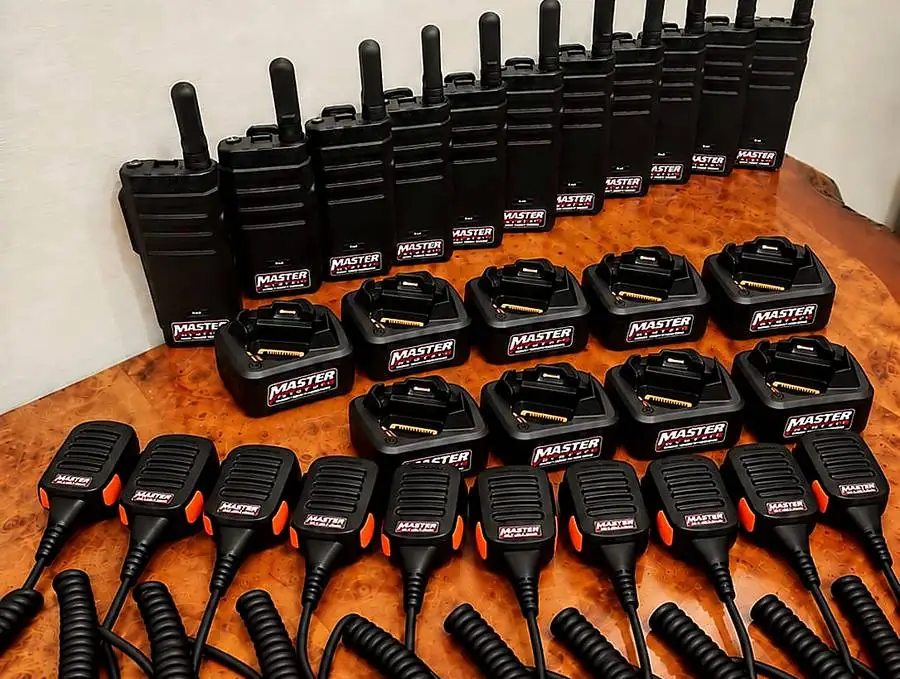 A full Master System kit: radios, charging docks and speaker mics, all labeled